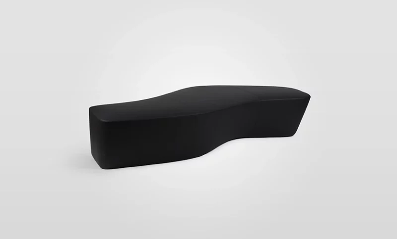 A black curved bench on a white background.